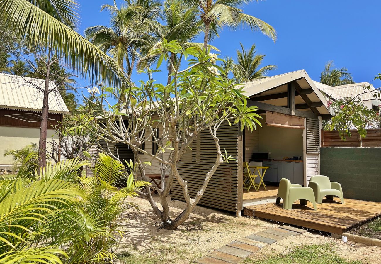 Tropical garden with palm trees and guest house Villa des Parfums La Saline